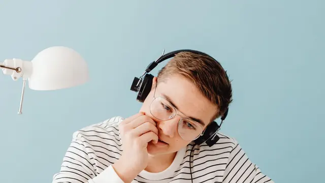 Student in headphones concentrating on listening practice
