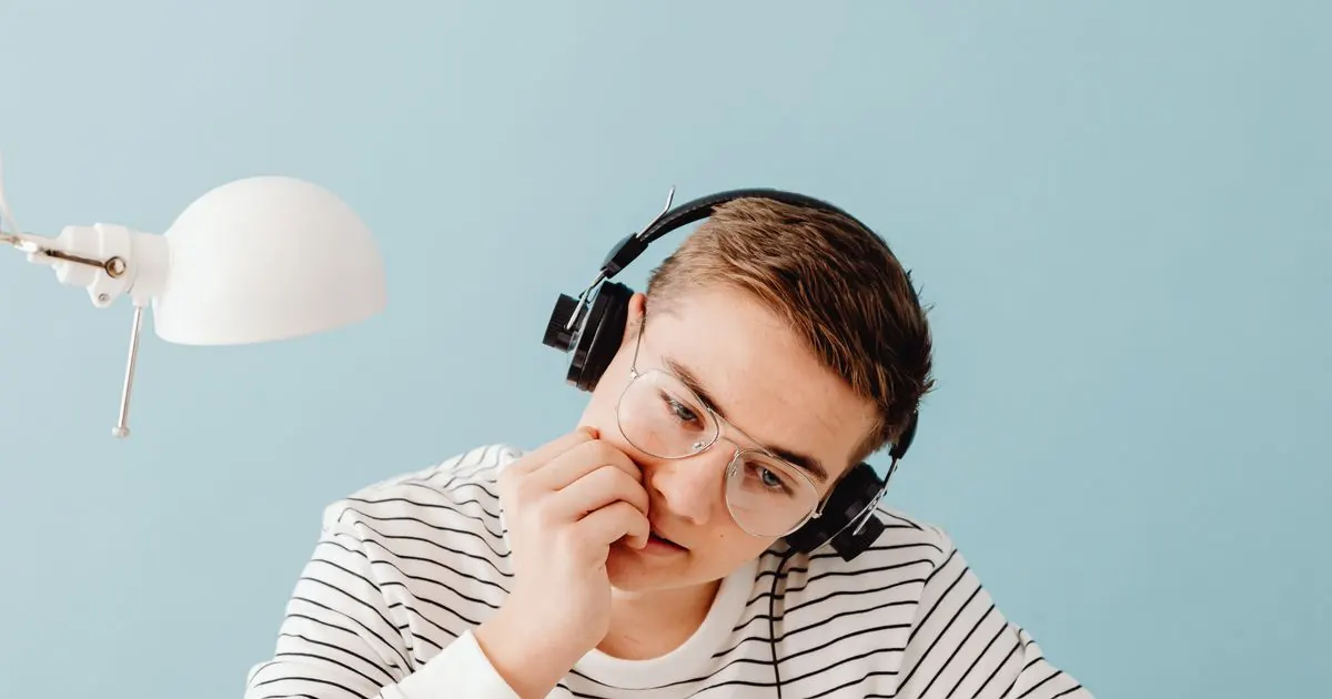 Student in headphones concentrating on listening practice
